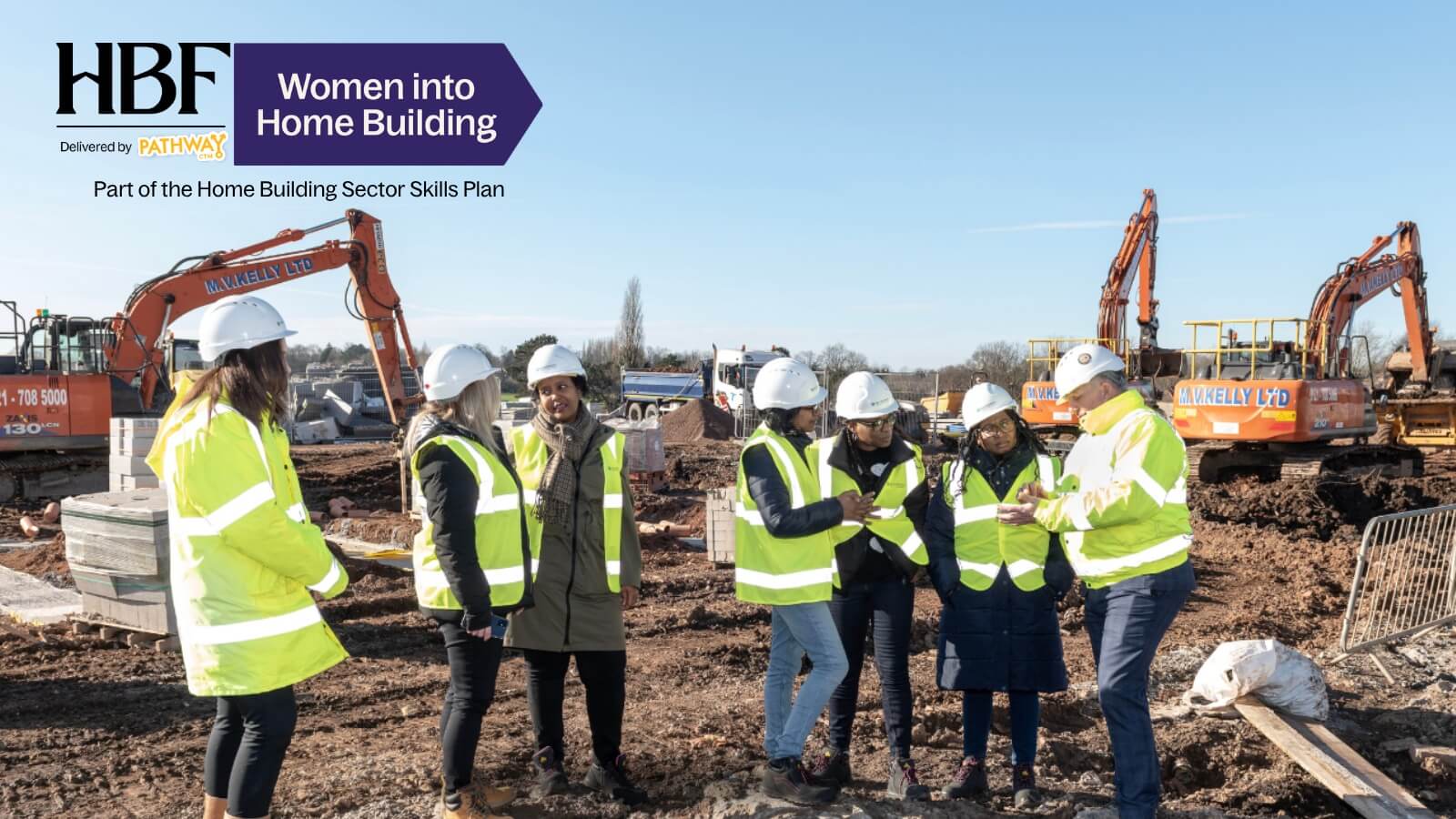 Women in hi-vis and hard hats on a Women into Home Building site visit