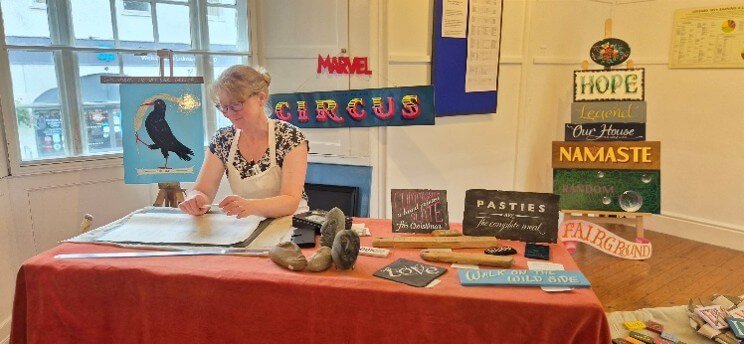 Joanna Hughes demonstrating traditional signwriting