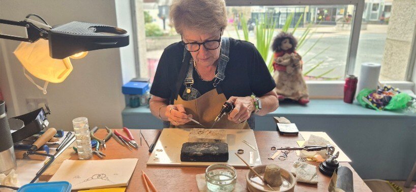Karen Burden demonstrating silver and copper jewellery making