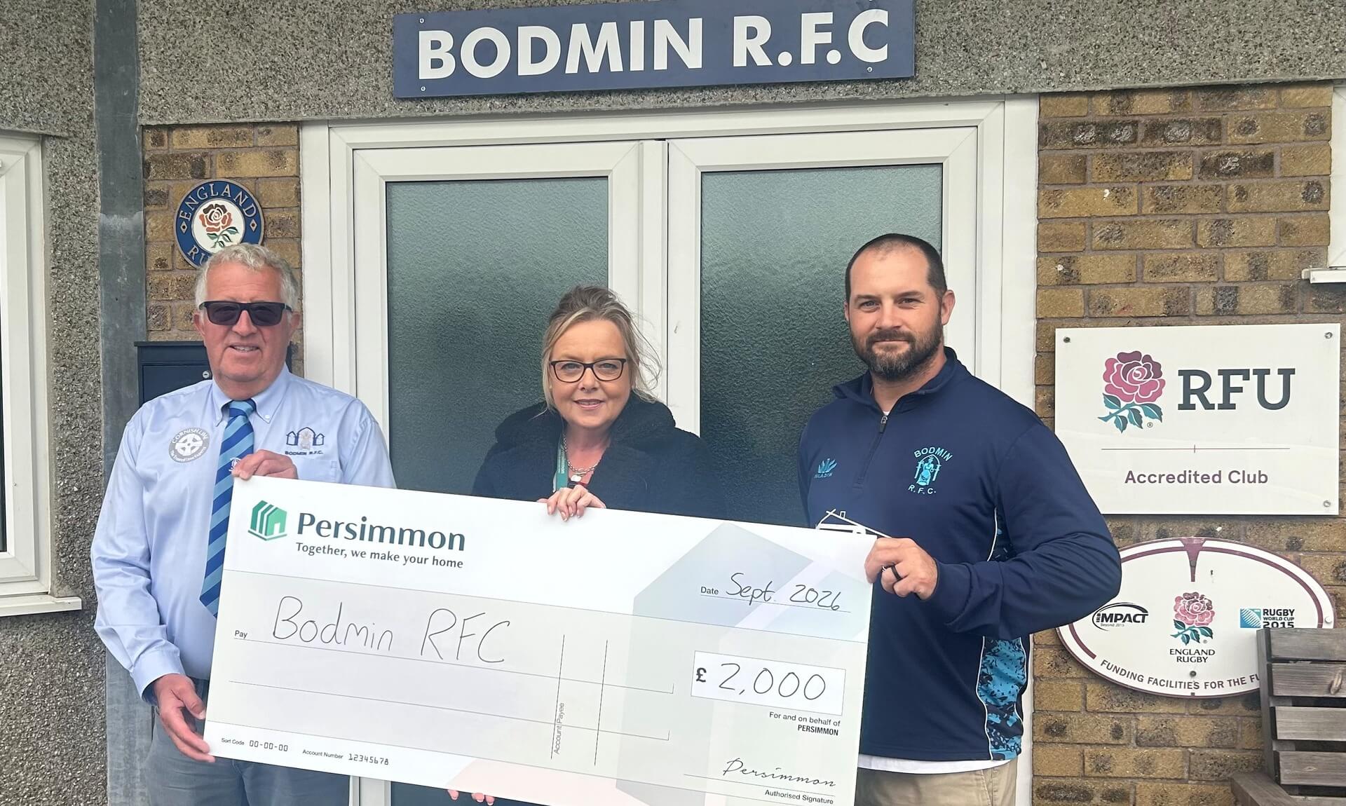 Persimmon Homes presenting a £2,000 cheque to Bodmin RFC outside the clubhouse