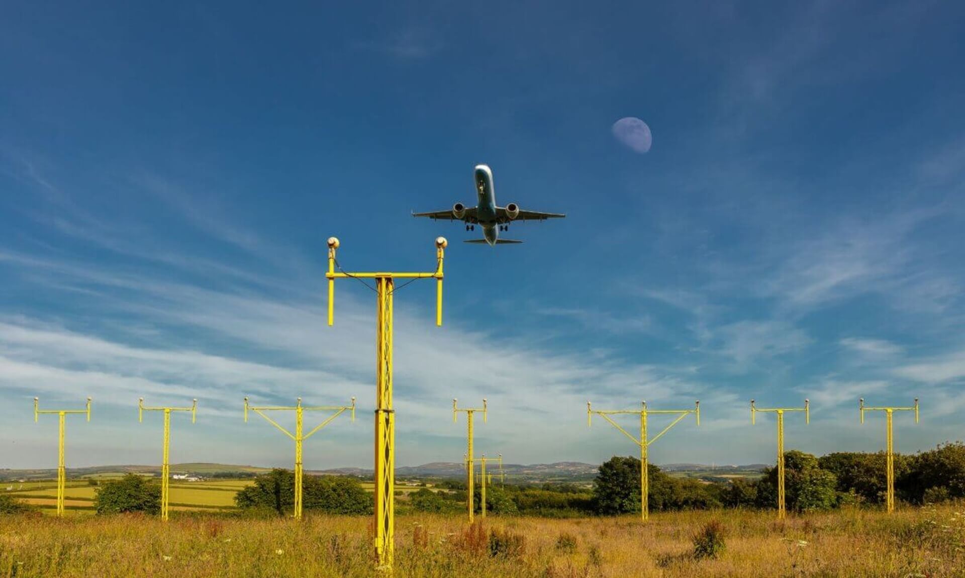 A plane comes in to land over the approach lights at Cornwall Airport Newquay