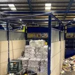 Forklift loader moving baled paper at a Cornwall recycling facility