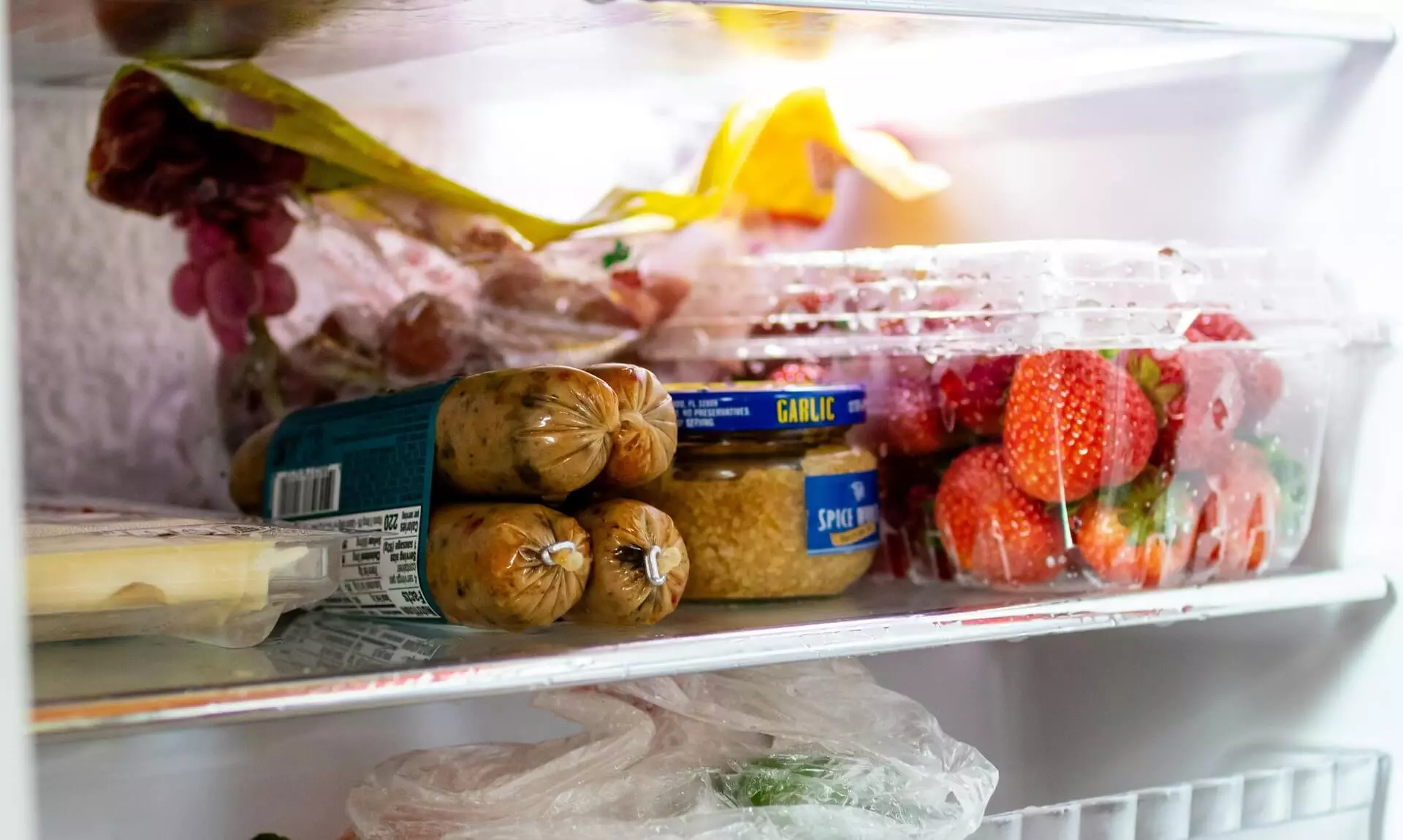 An open fridge in a Cornwall kitchen packed with fresh food