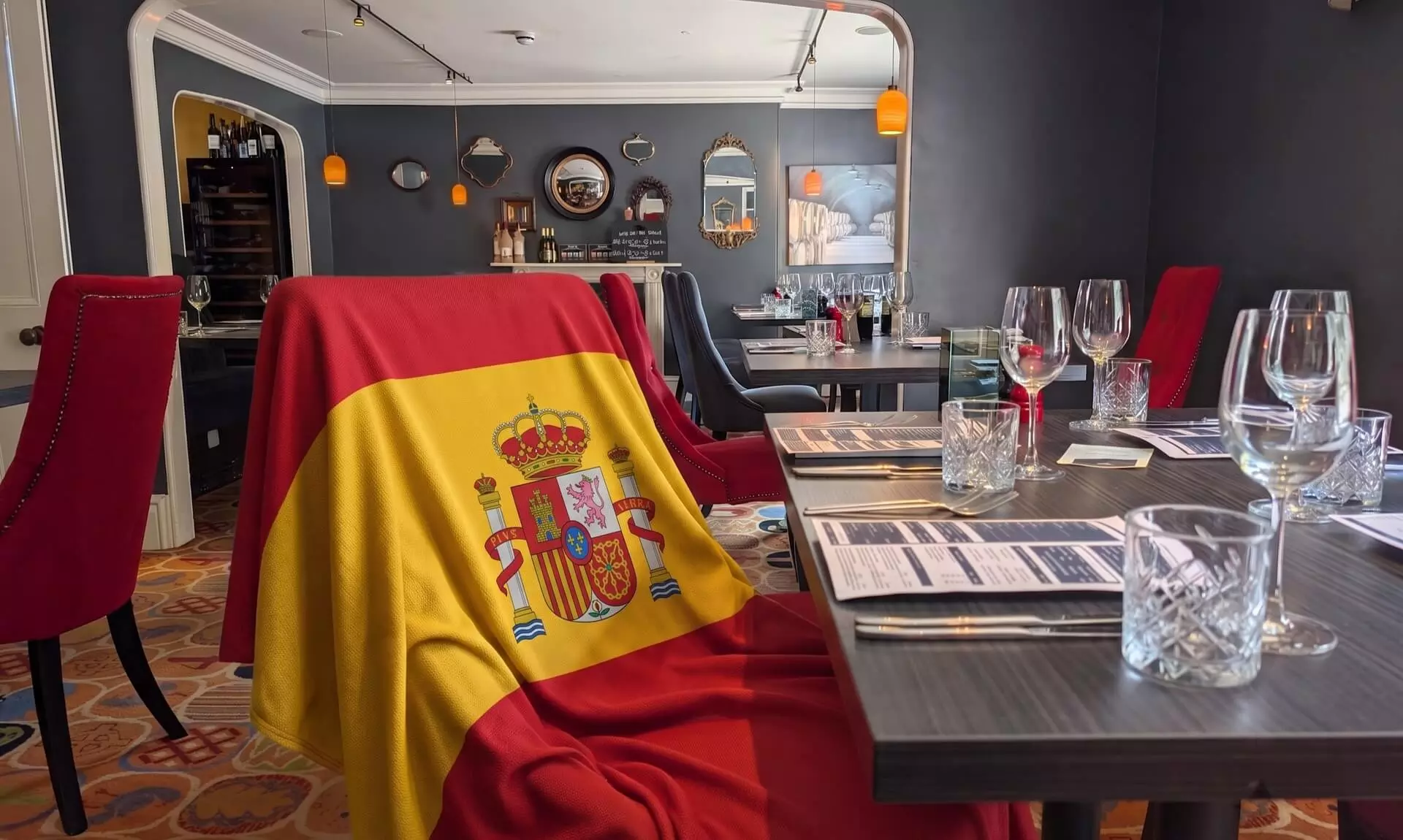 Table set for Spanish Nights at Flory Restaurant in Bodmin, with a Spanish flag draped over a chair