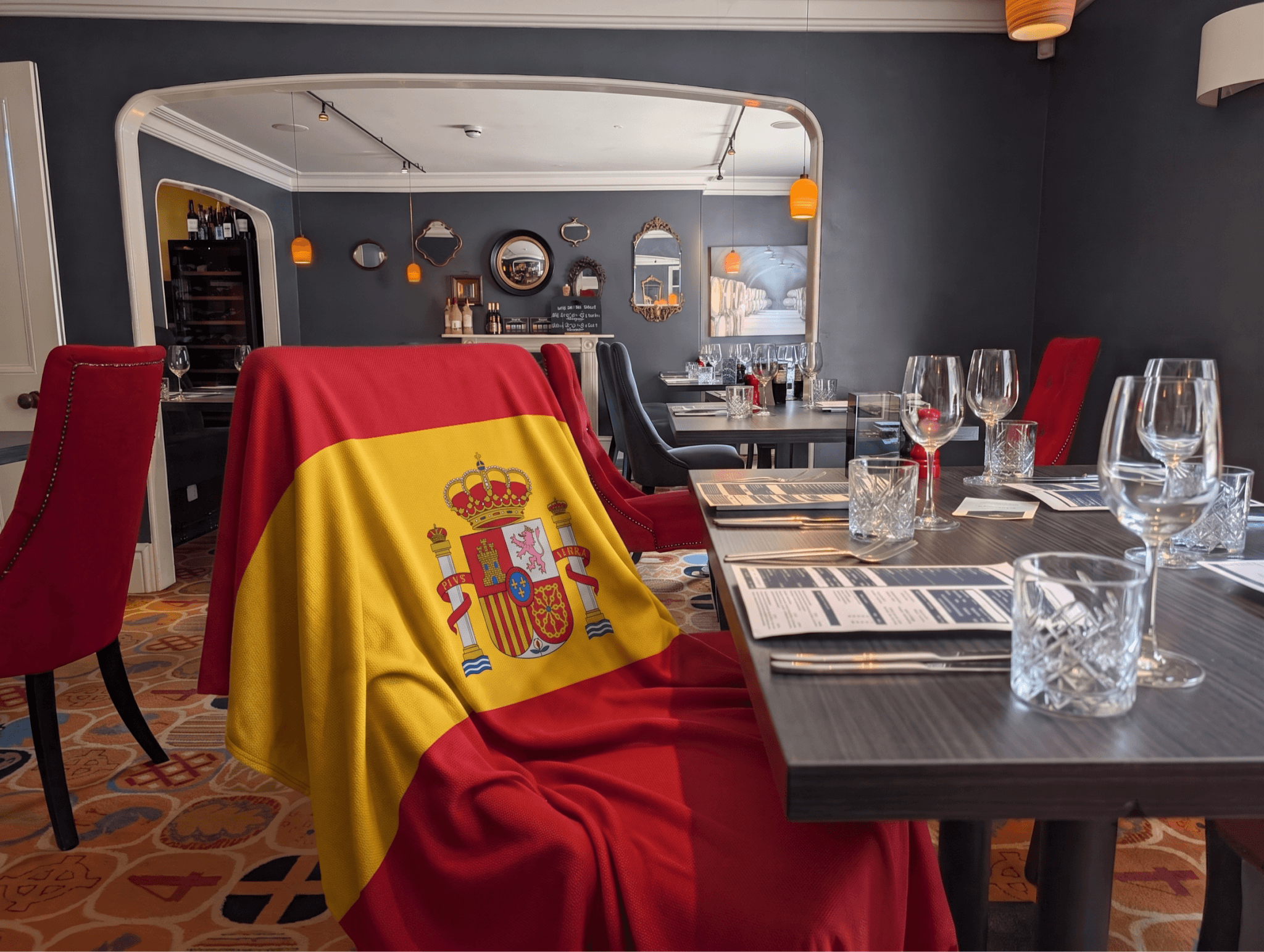Table set for Spanish Nights at Flory Restaurant in Bodmin, with a Spanish flag draped over a chair