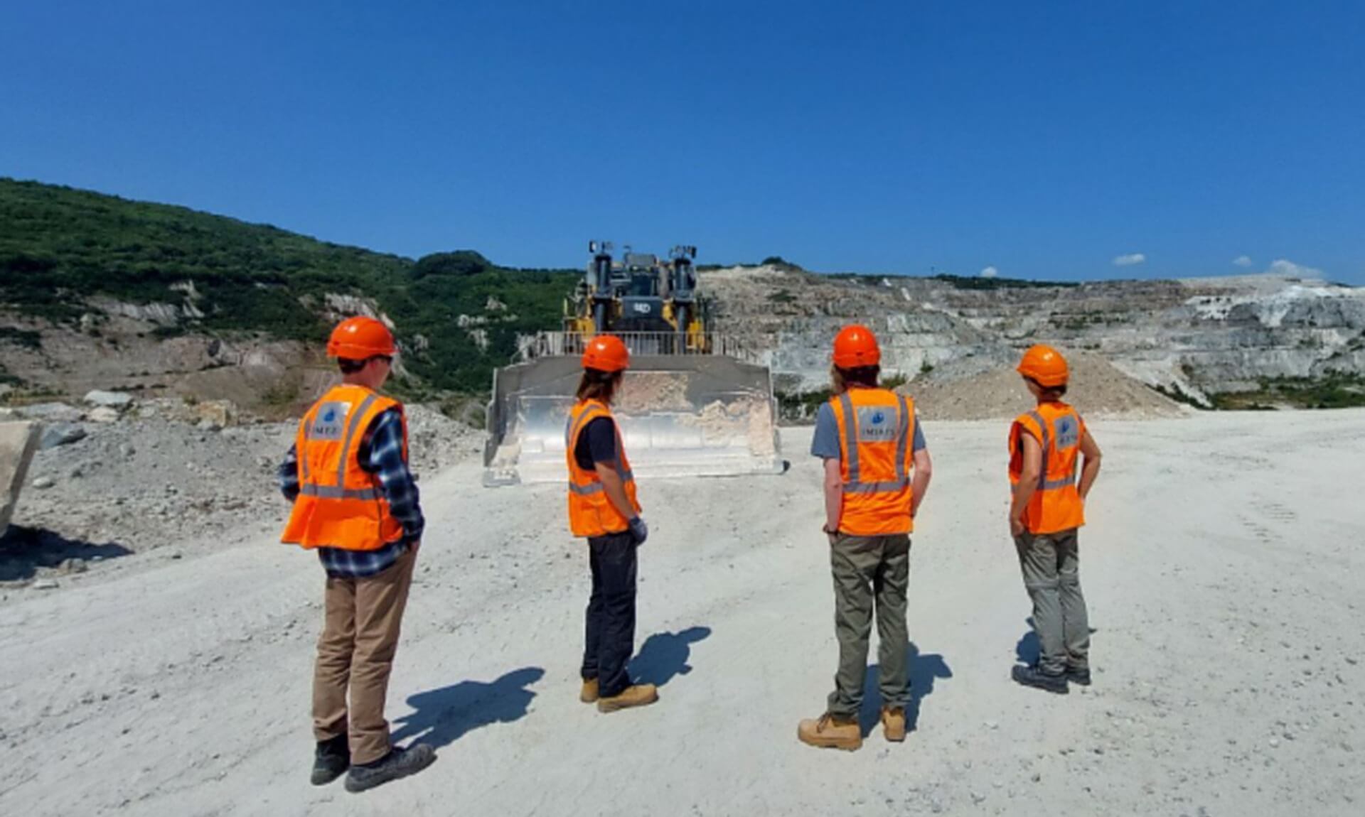 Students in high-vis and hard hats at an Imerys quarry in Cornwall