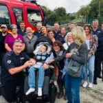 Luke Hodge with family and fire crew after his Pride of Britain win