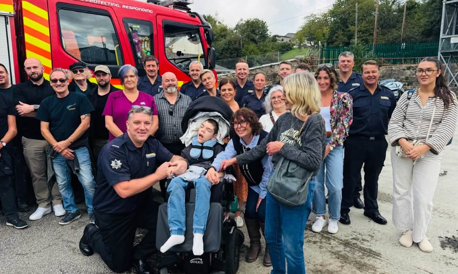Luke Hodge with family and fire crew after his Pride of Britain win
