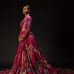 Lekazia Turner wearing The Red Dress with its long embroidered train