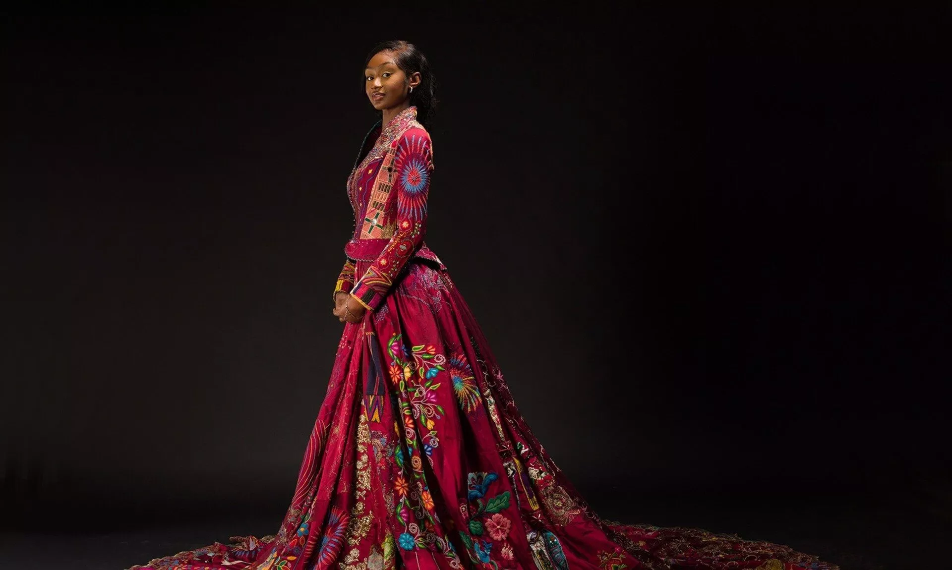 Lekazia Turner wearing The Red Dress with its long embroidered train
