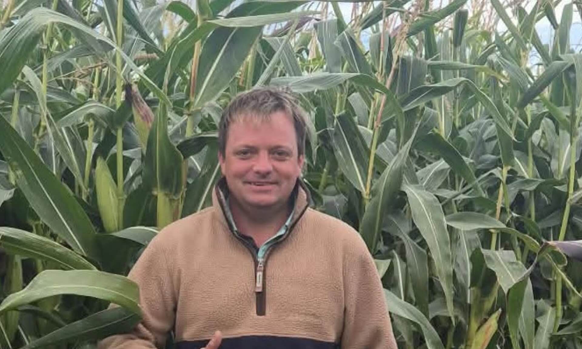 Man giving a thumbs up in front of tall maize at St Merryn Maize Maze and Sunflower Trail