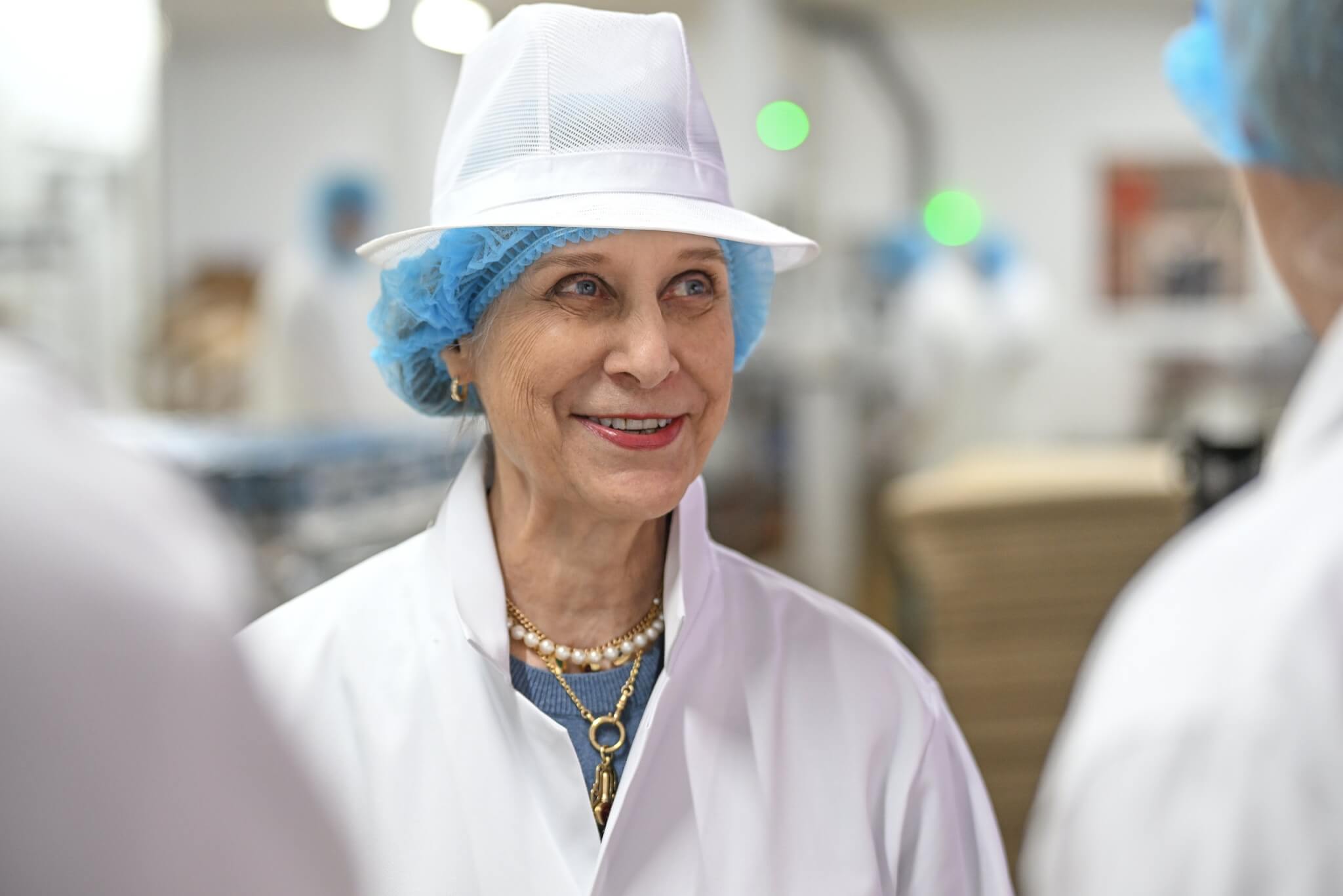 HRH The Duchess of Gloucester in hygiene whites touring the cottage cheese facility