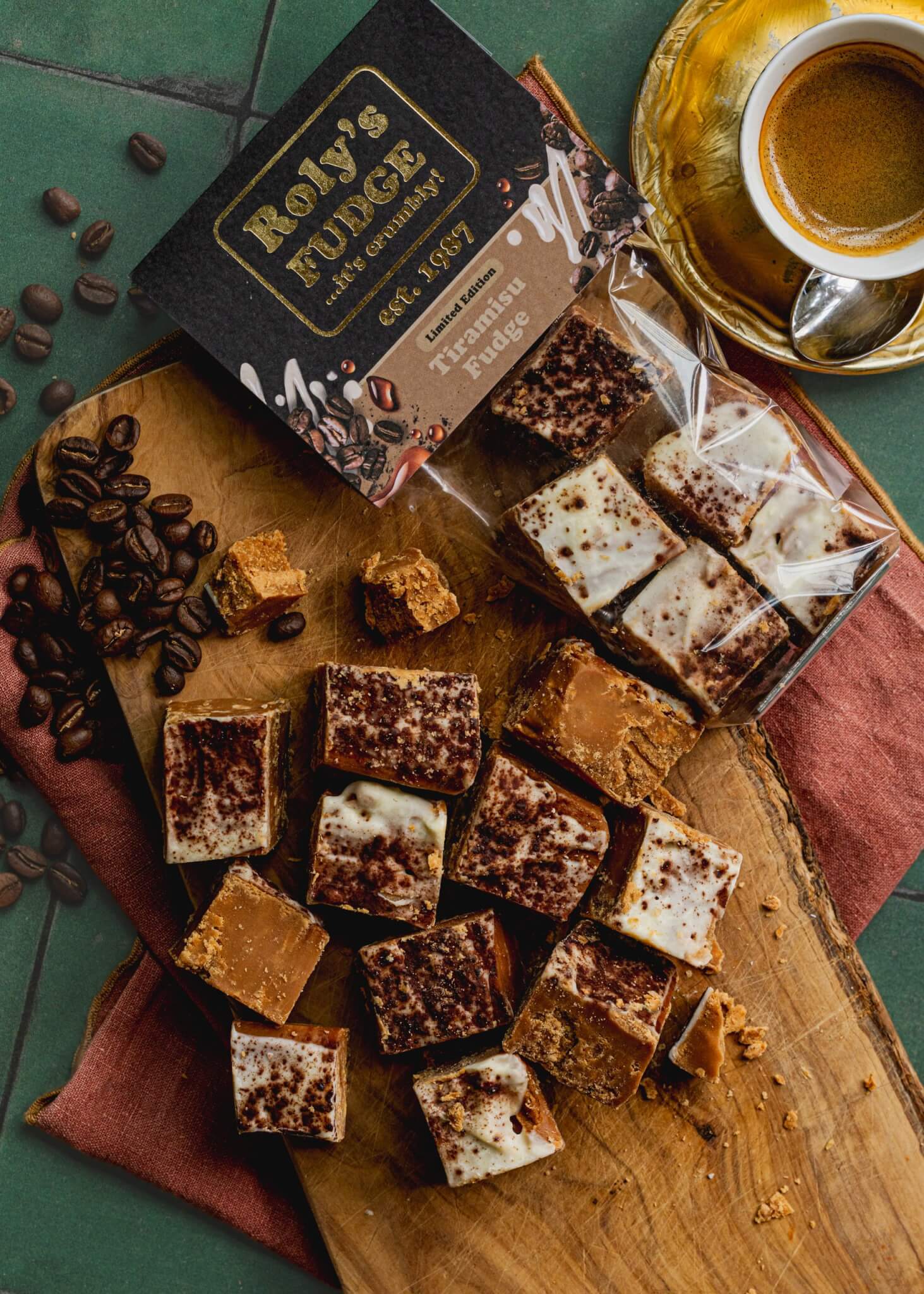 A bag of Roly's Tiramisu Fudge with coffee beans and an espresso