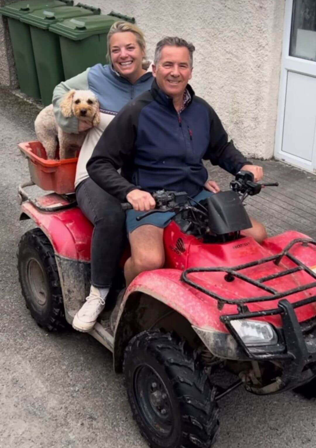 Two people and a dog on a quad bike at Tregavone Farm