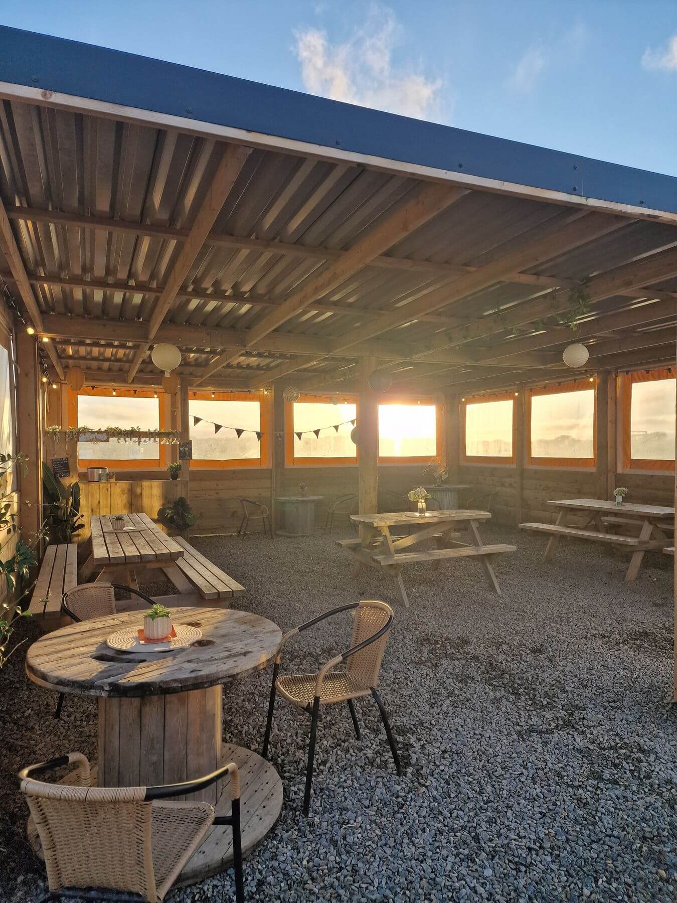 Covered seating area at Tregavone Kitchen and Bar at sunset