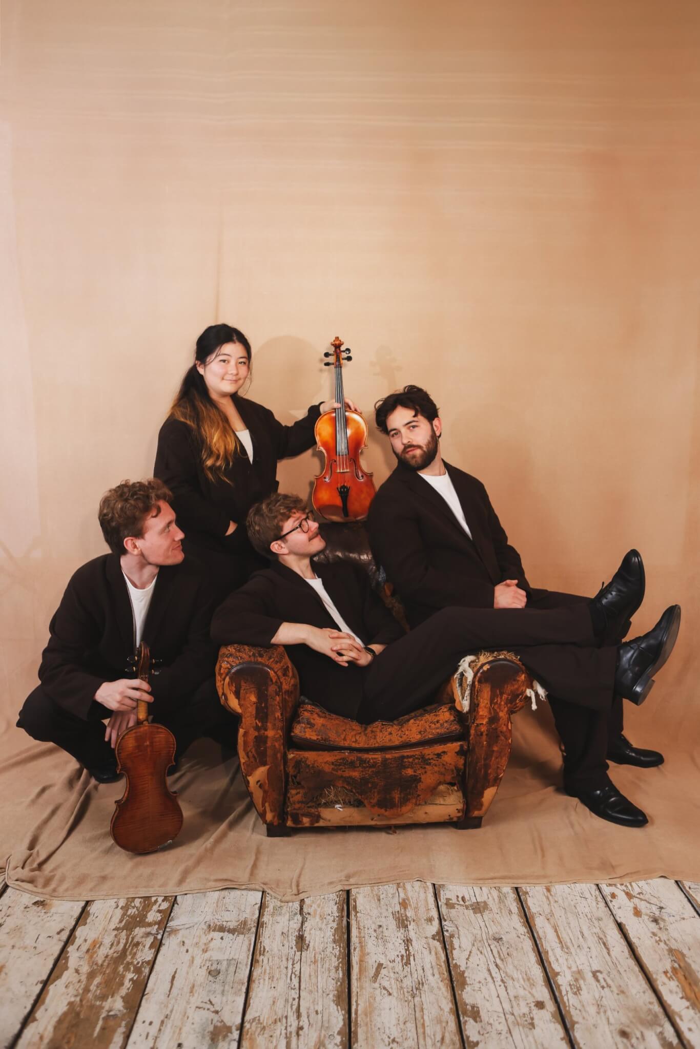 The Elmore Quartet around an armchair with a viola