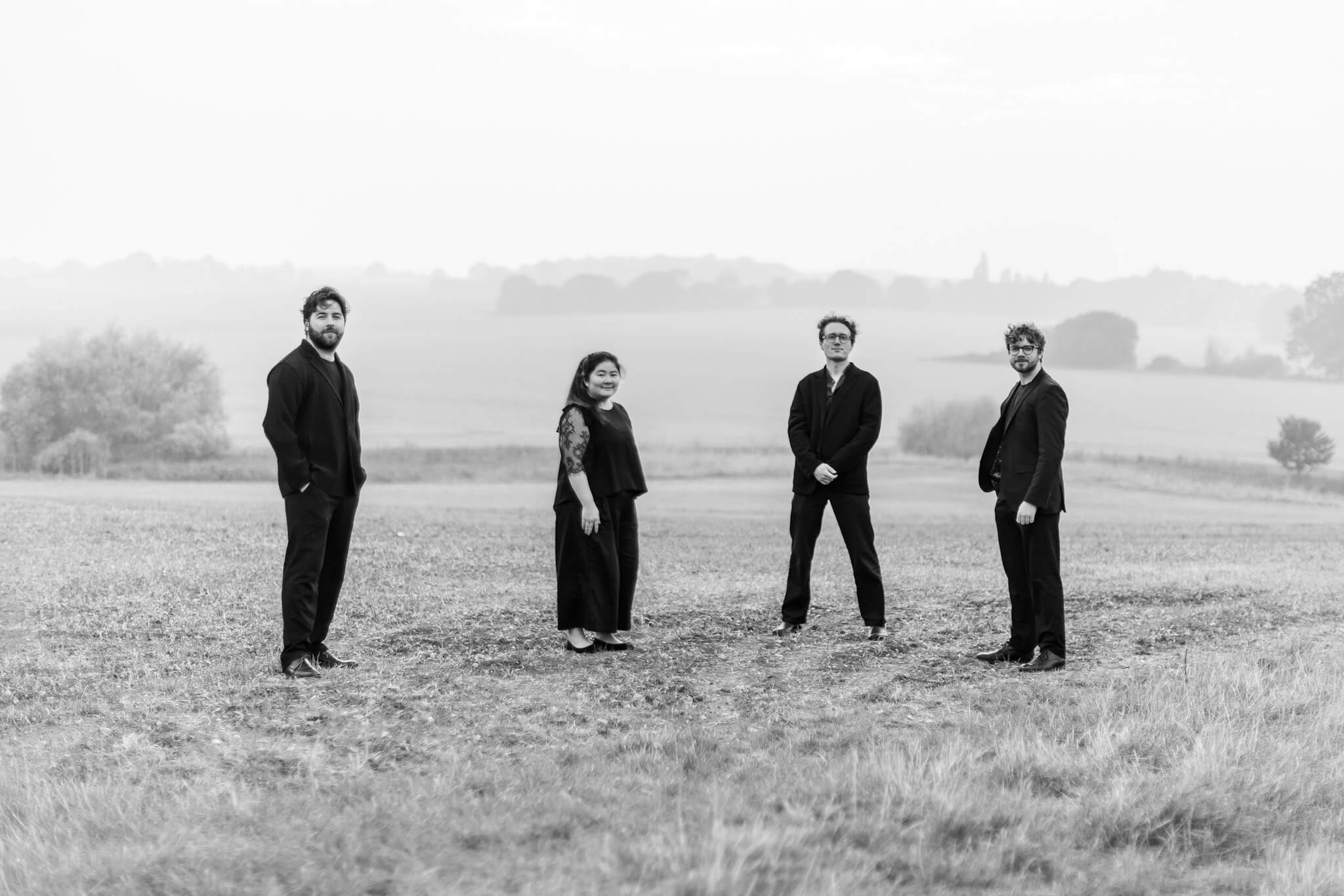 The Elmore Quartet standing in a misty field