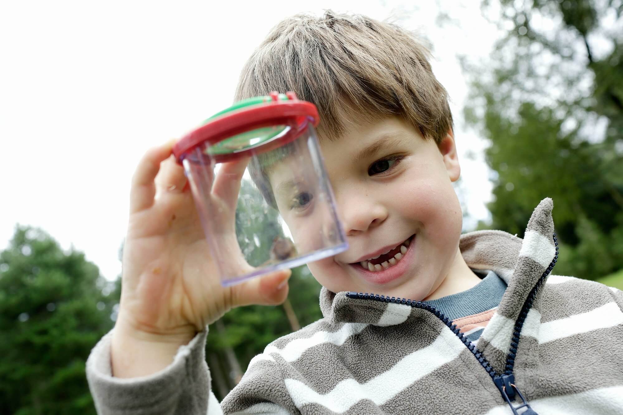 A child looking through a bug viewer