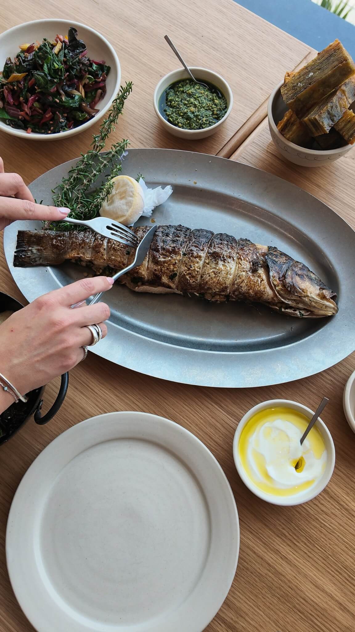 Stuffed market fish being served at the table at MOR