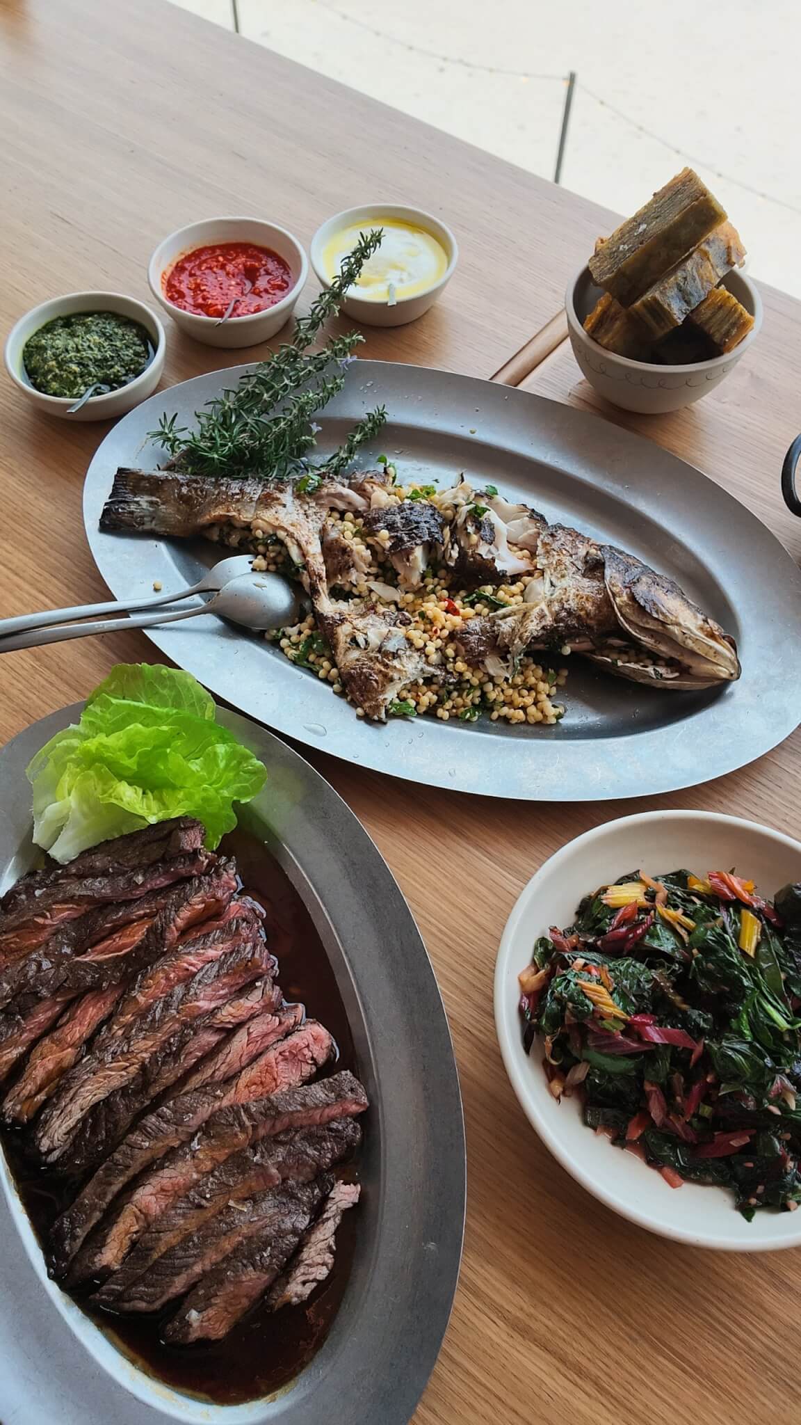 Stuffed market fish and sliced bavette steak with greens and condiments at MOR