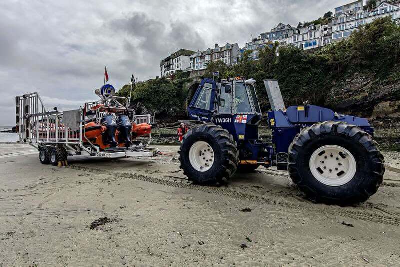 Looe RNLI launch tractor with D Class lifeboat on the beach