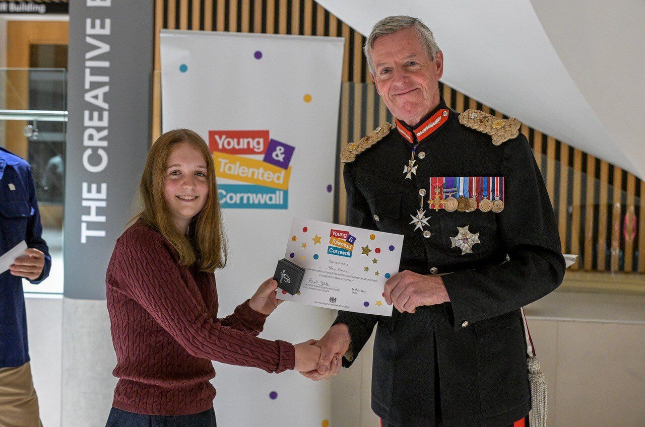 A young writer receiving her certificate from the Lord Lieutenant of Cornwall