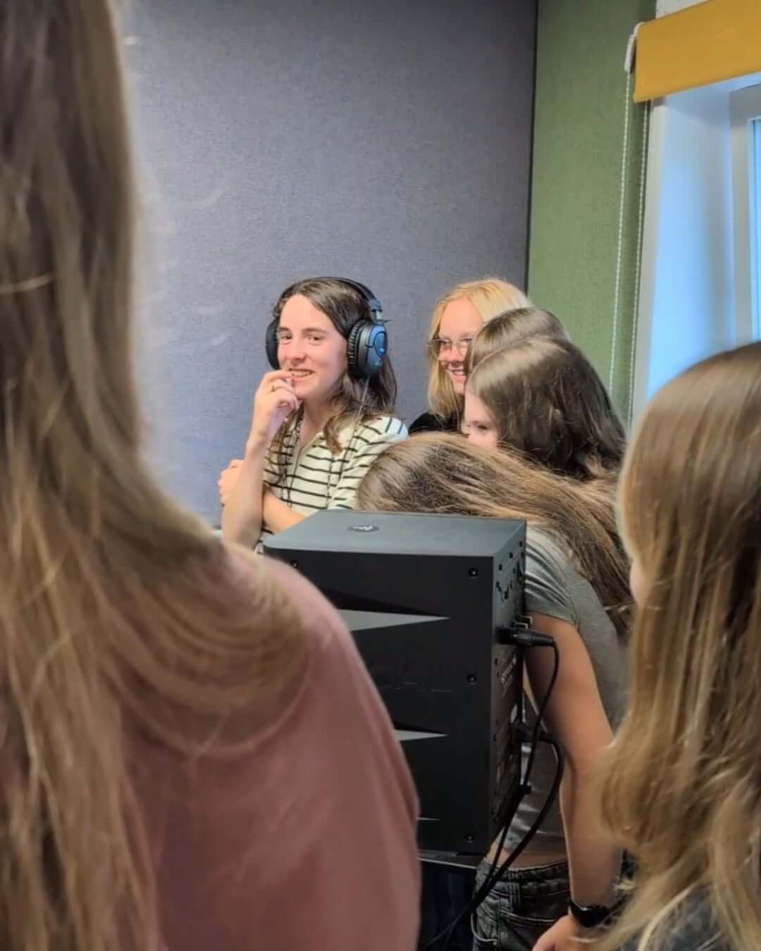 Falmouth youth councillors wearing headphones in the Source FM studio