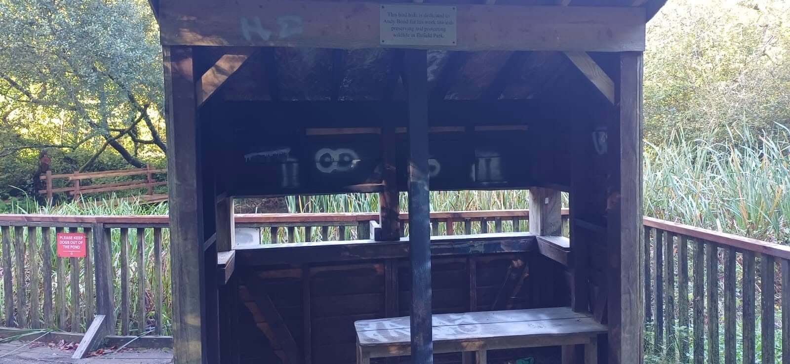 Graffiti inside the wooden bird hide beside the pond in Camelford