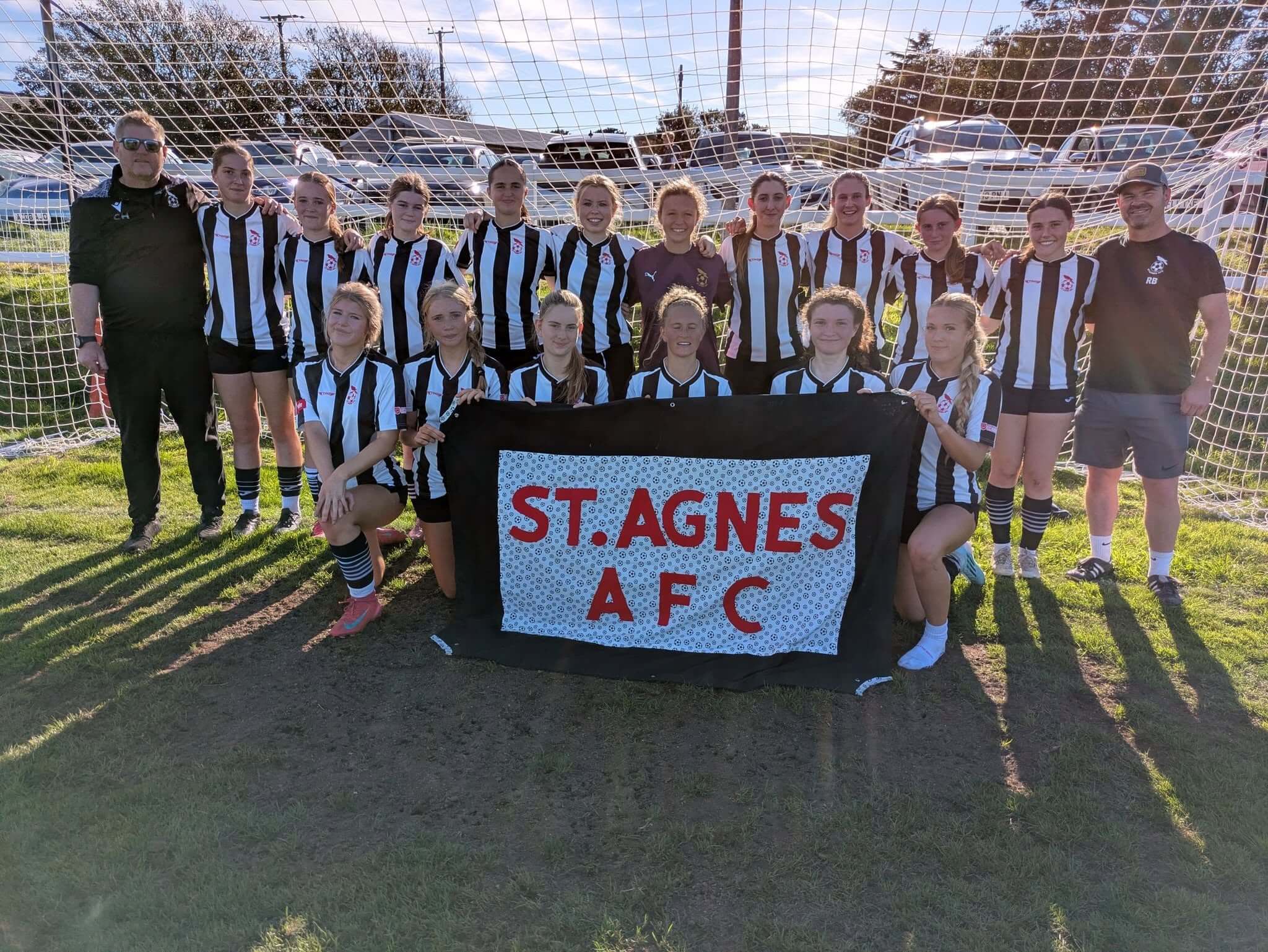 St Agnes AFC Ladies team photo with a St Agnes AFC banner