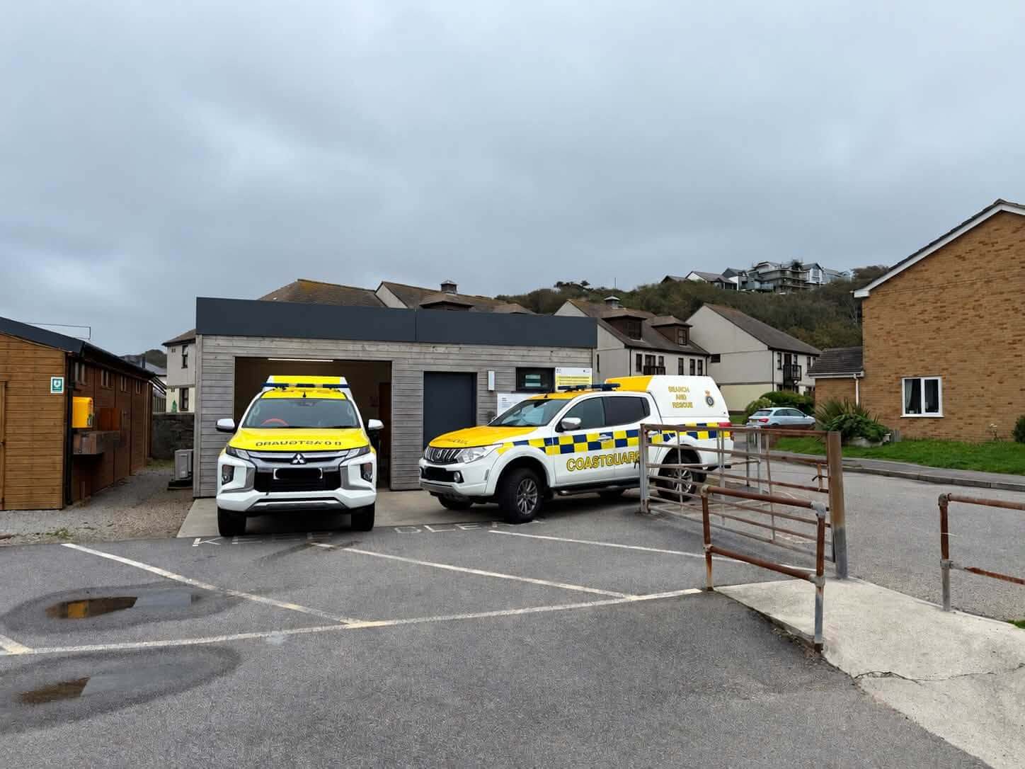 Two Coastguard search and rescue vehicles parked outside a building in Portreath