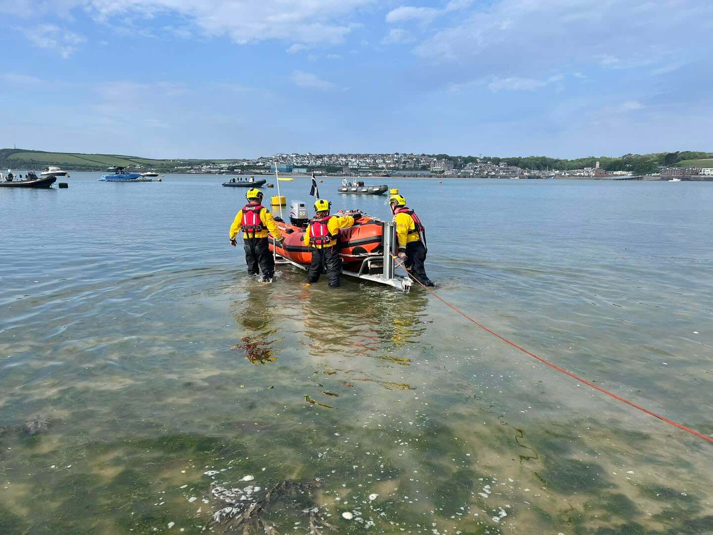 Rock RNLI volunteer crew launching the D class lifeboat into the Camel estuary