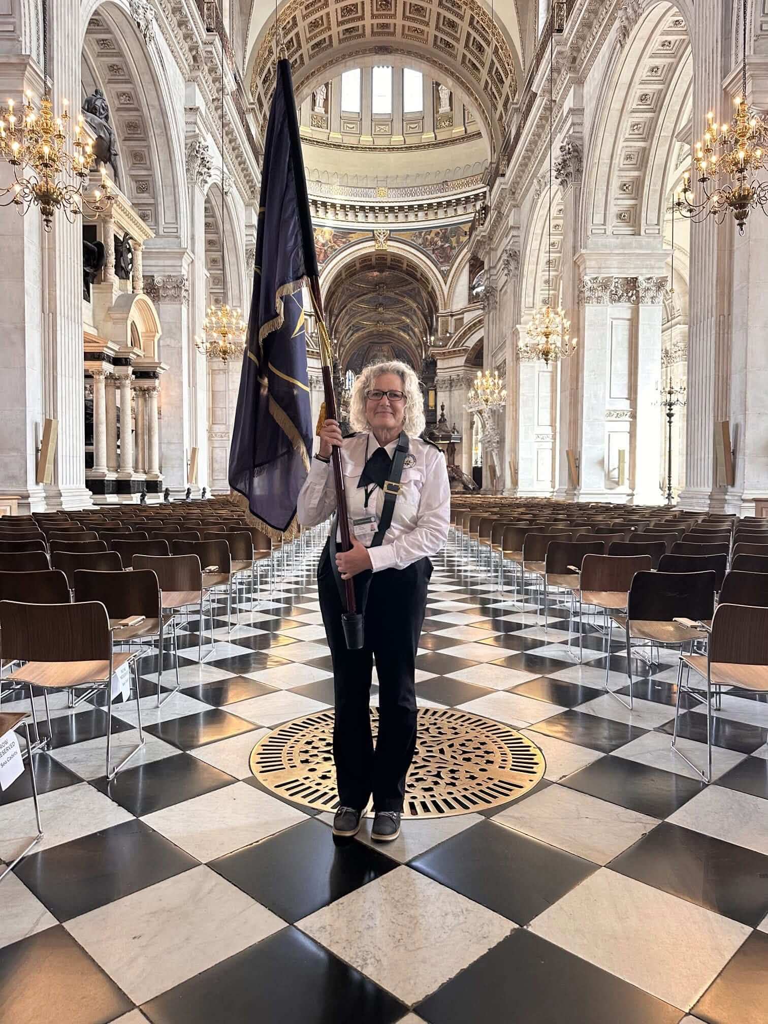 NCI St Agnes Head watchkeeper holding the National Coastwatch Institution standard in St Paul's Cathedral