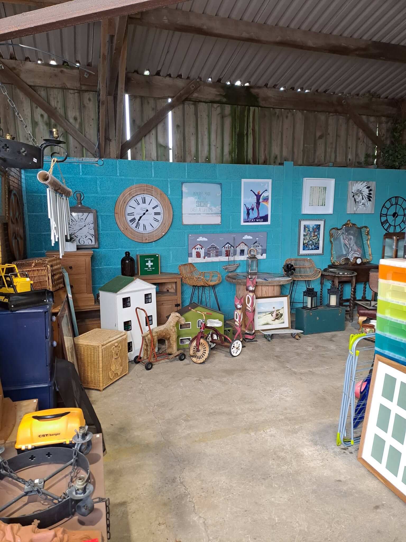 Clocks, prints, dolls' houses and a tricycle inside the Kernow Reuse Shop in Newquay