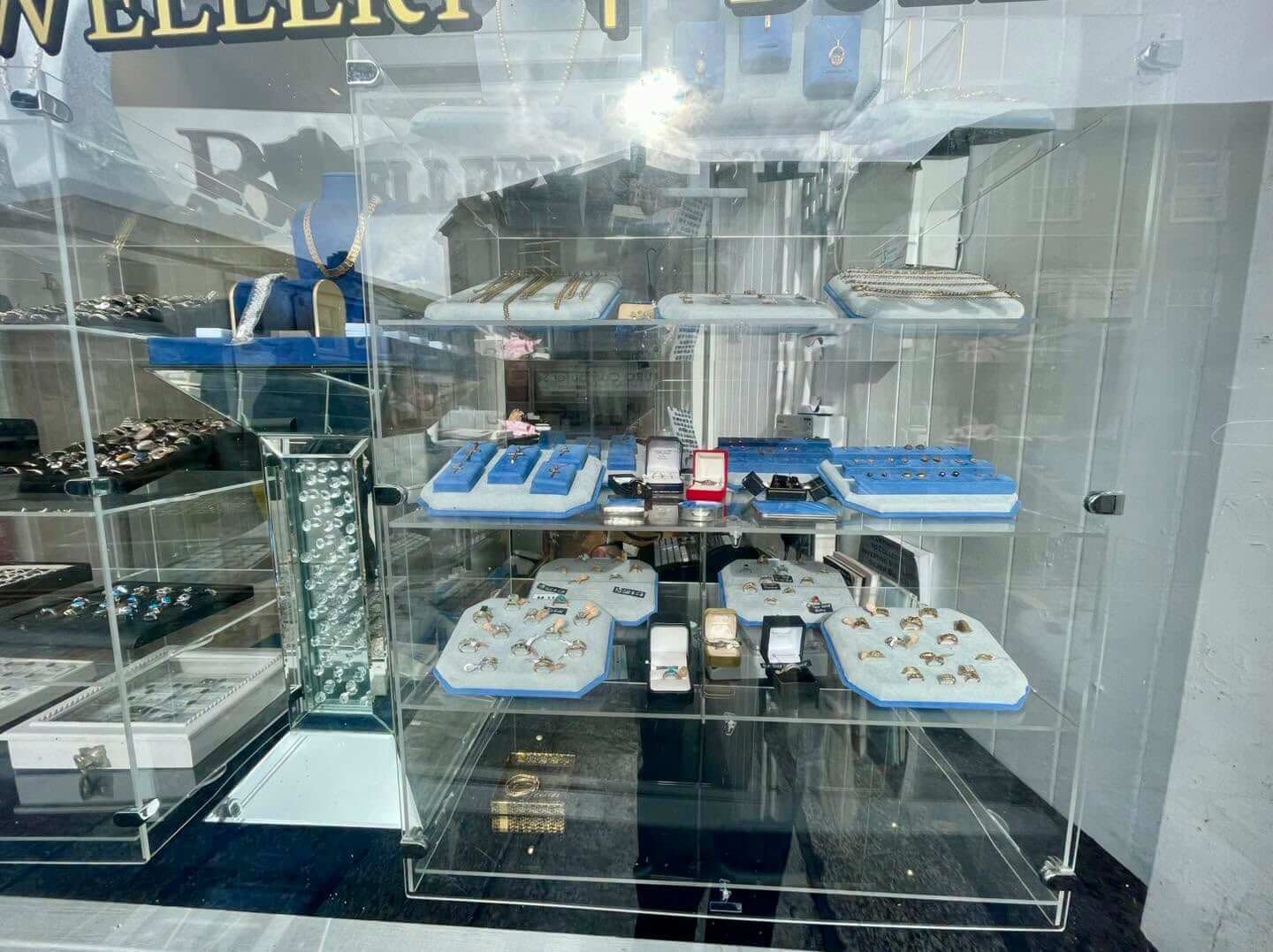 Gold rings, chains and pendants in the window of Bailey's, Truro