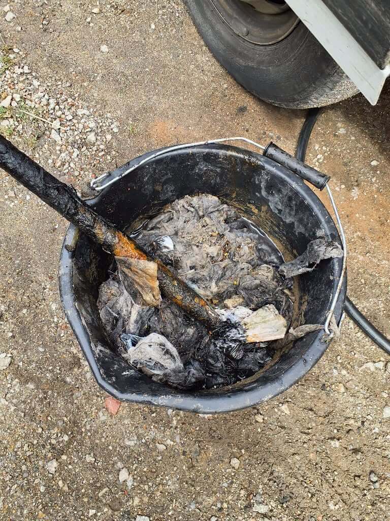 Bucket full of wet wipes and debris pulled from a blocked sewer