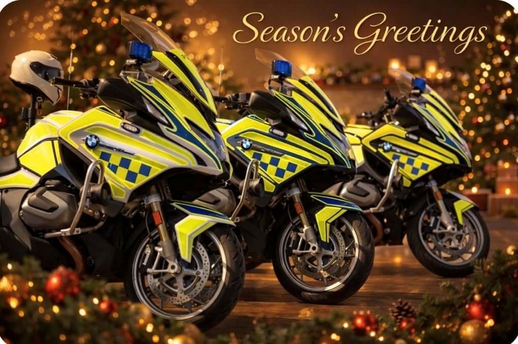 Three Devon & Cornwall Police BMW motorcycles in a festive setting