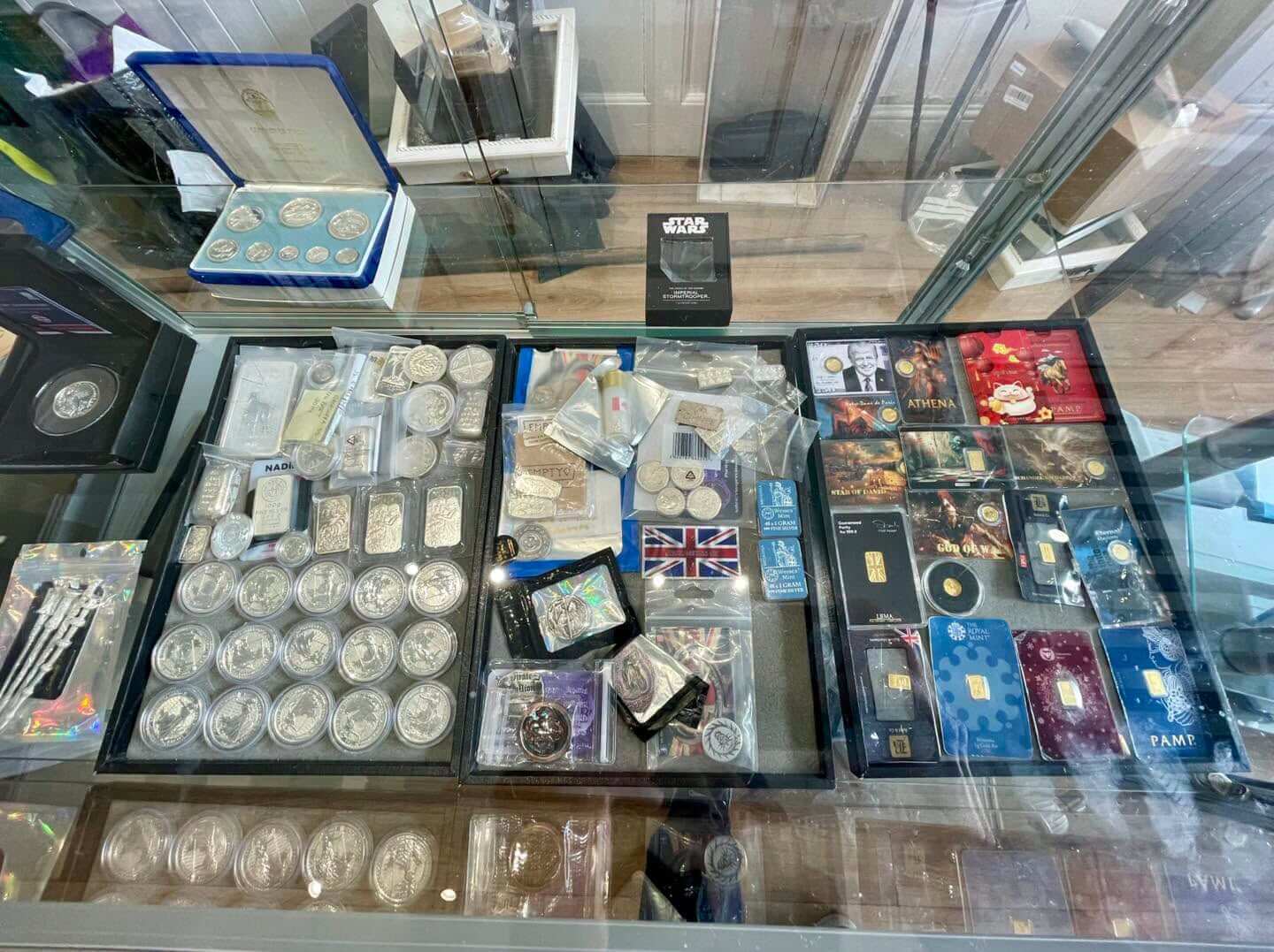 Silver coins and gold bars on display at Bailey's