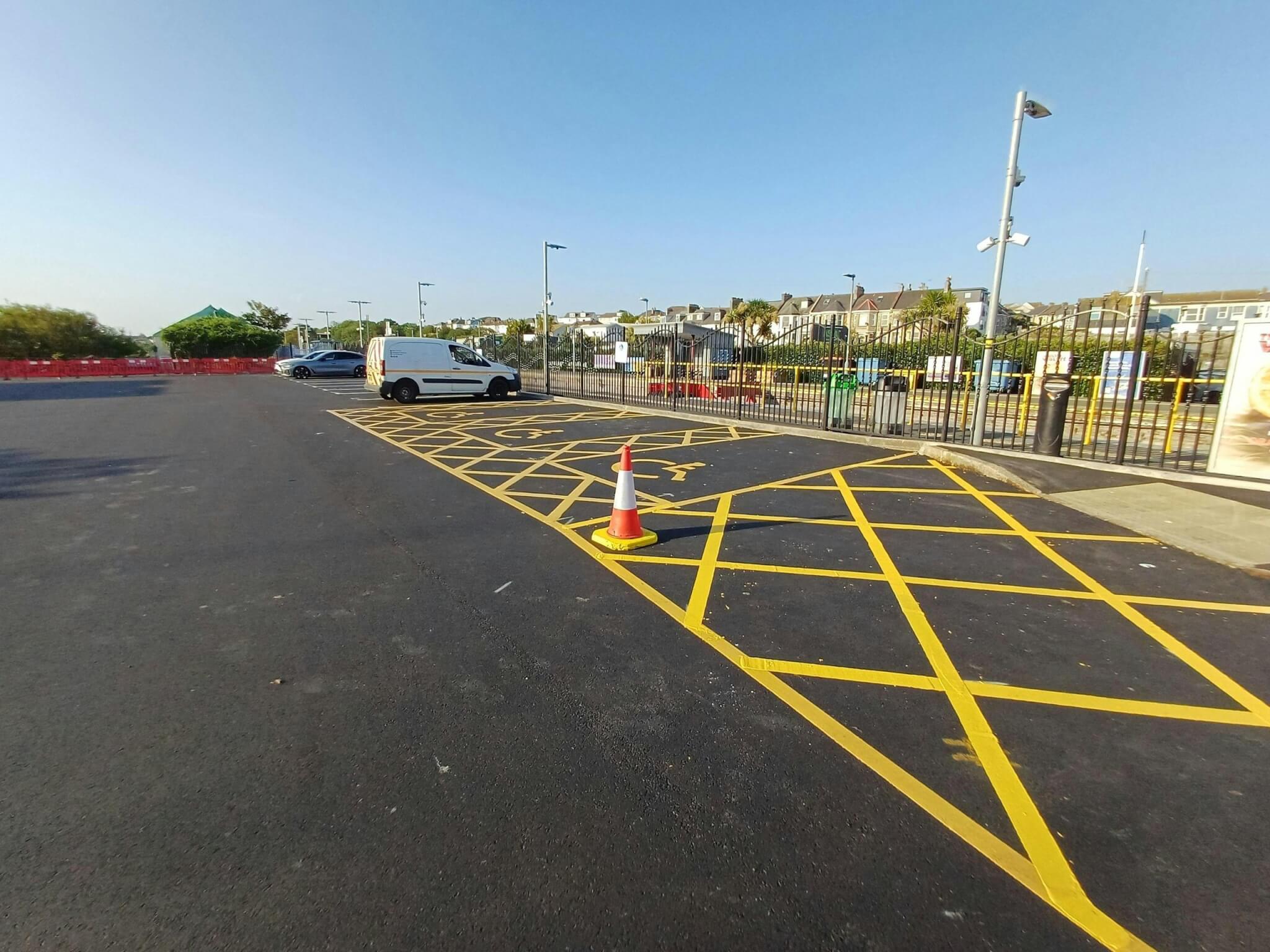 Newly resurfaced Newquay Railway Station car park with yellow hatched disabled bays