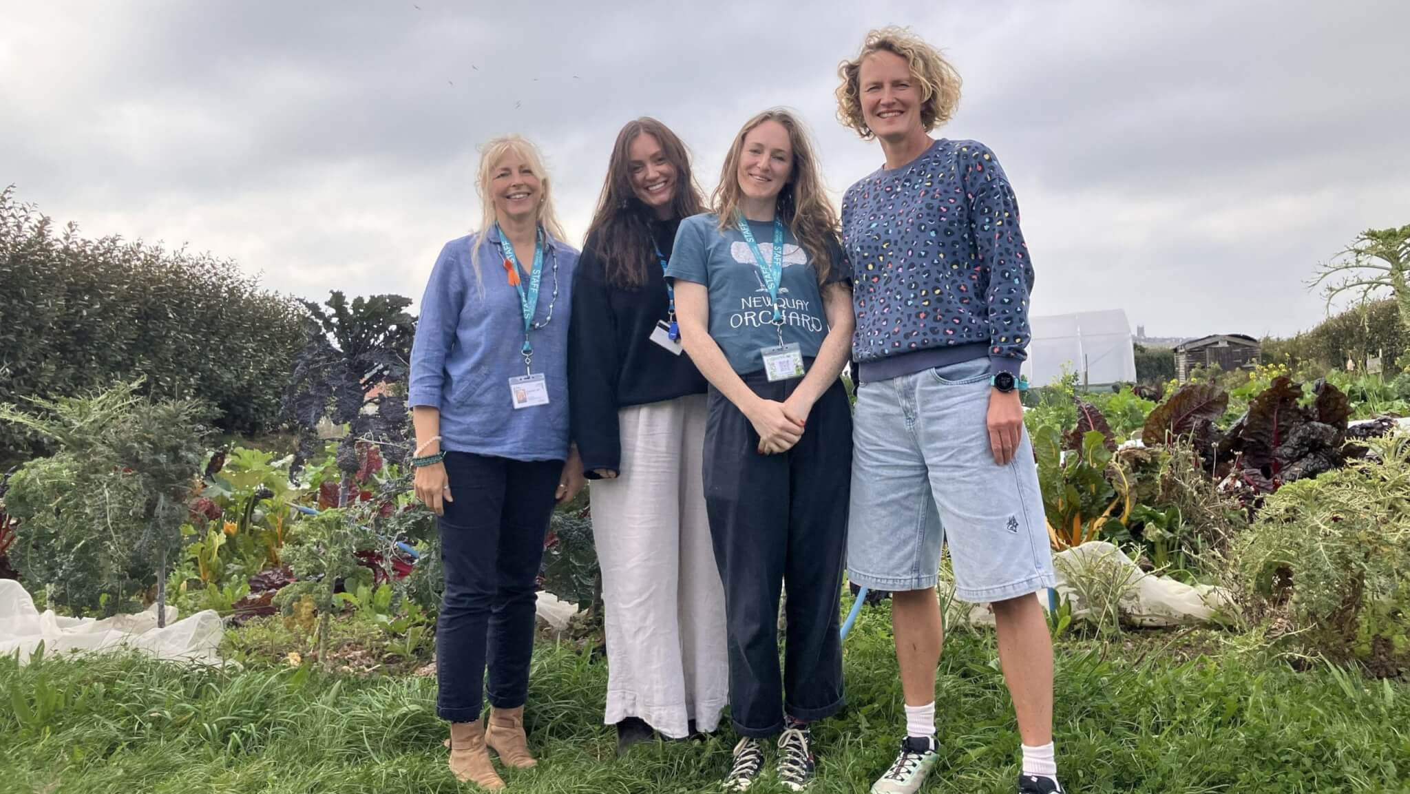 Four members of the Restormel CAMHS team standing in a vegetable garden