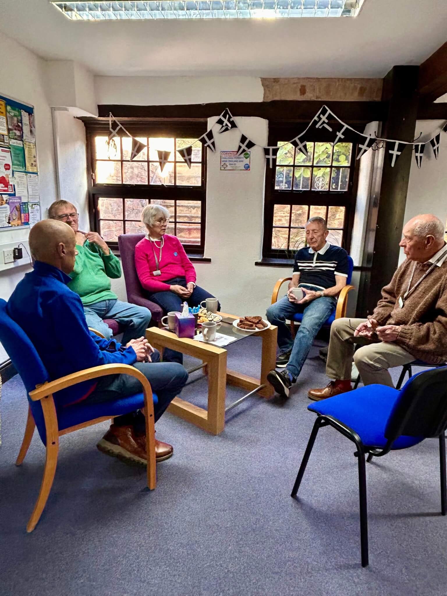 Volunteers sharing coffee and cake at CMA Launceston's office