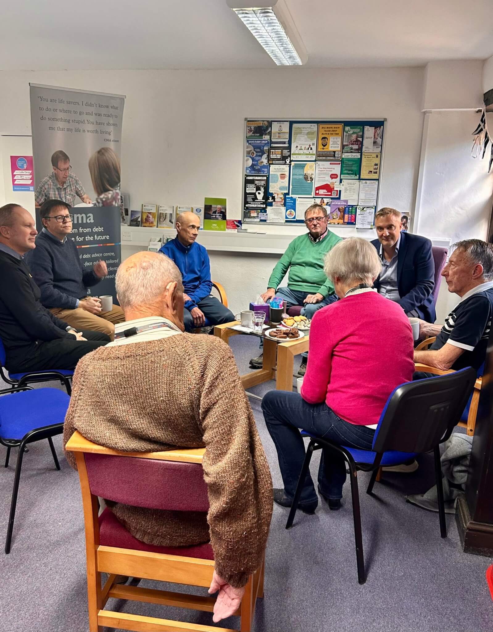 Guests talking in a circle at the CMA Launceston Challenge Poverty Week coffee morning