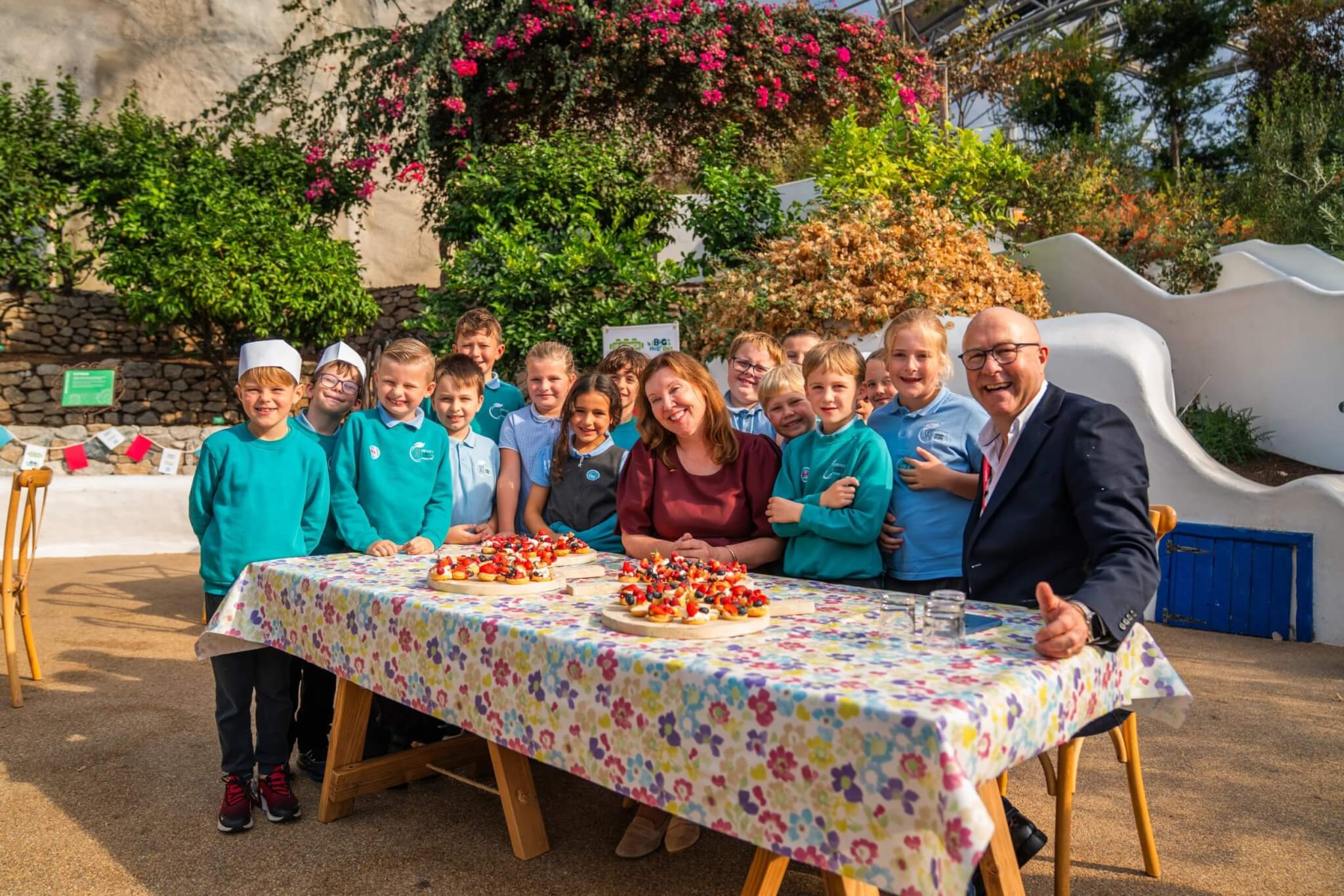 Sky Primary School pupils with Dame Rachel de Souza at a table of food in the Eden Project
