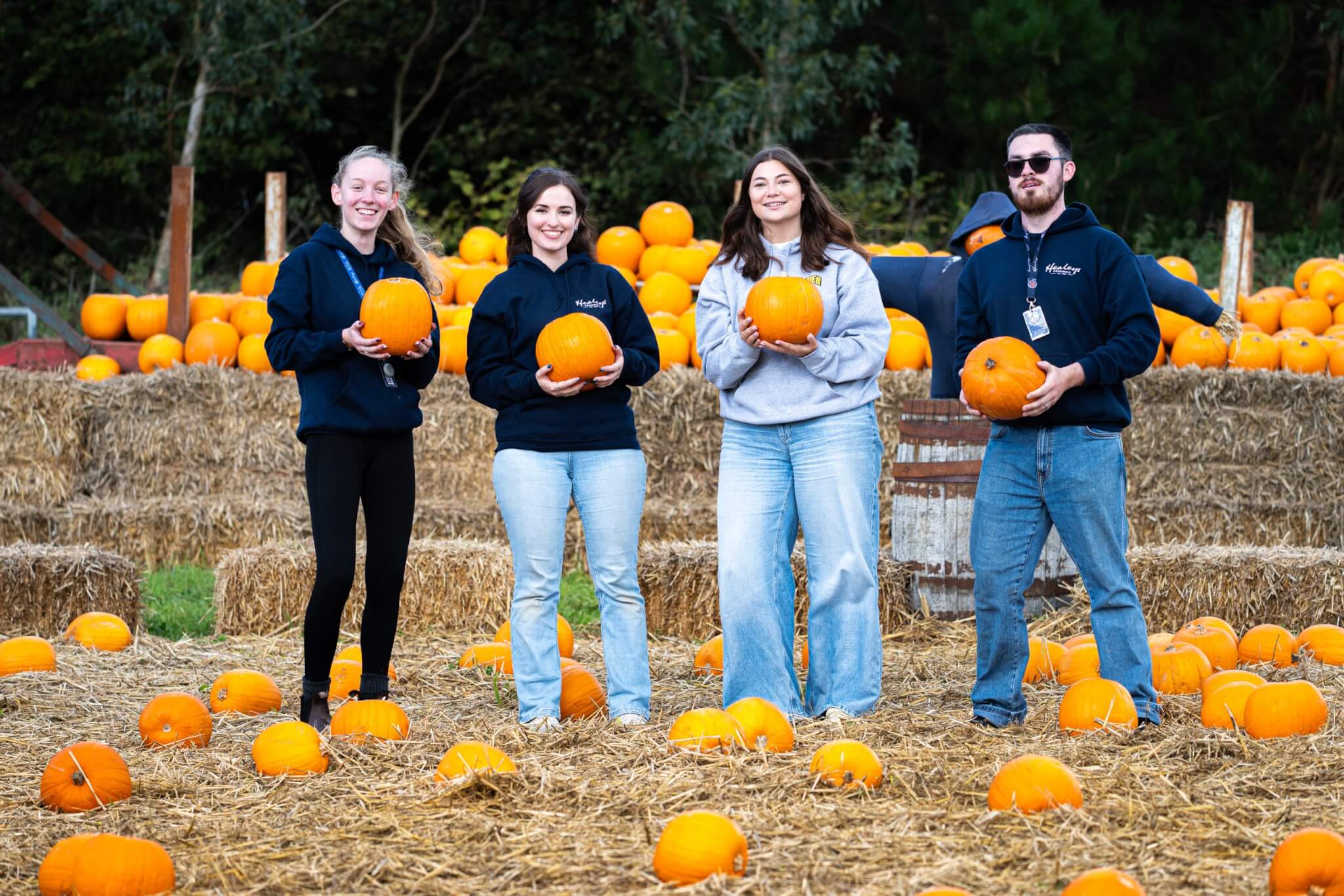 Healey's team holding pumpkins