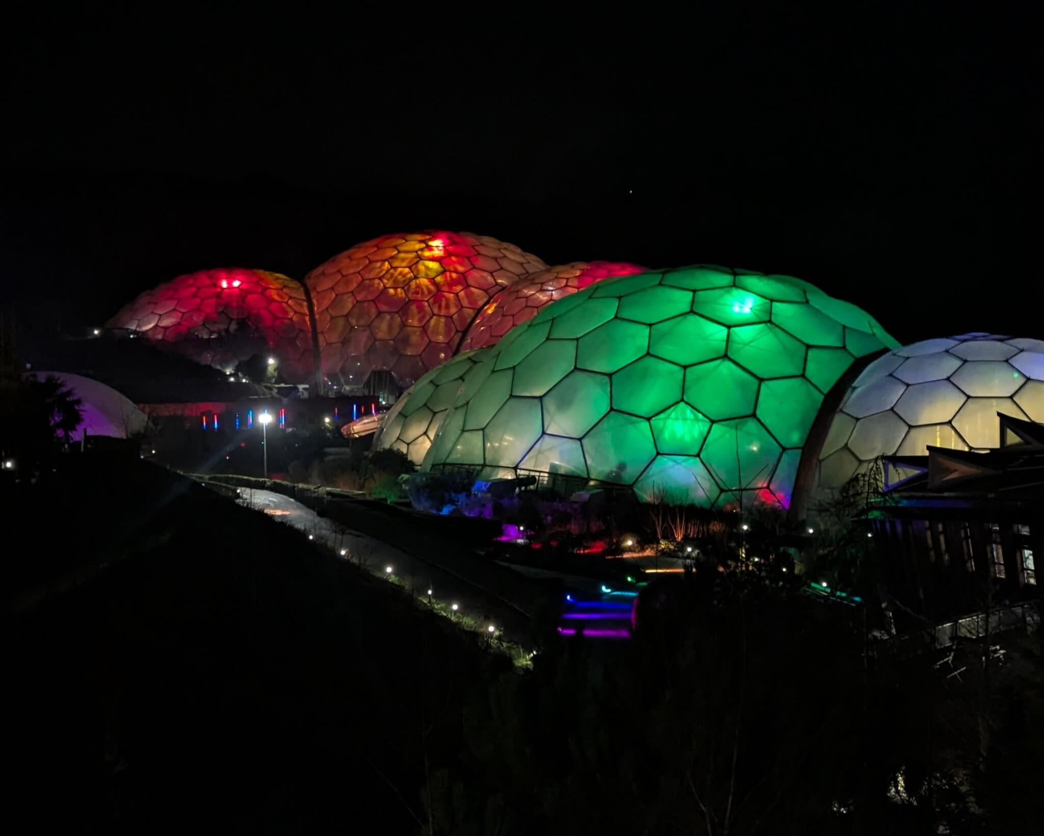 Eden Project biomes lit red, orange and green at night