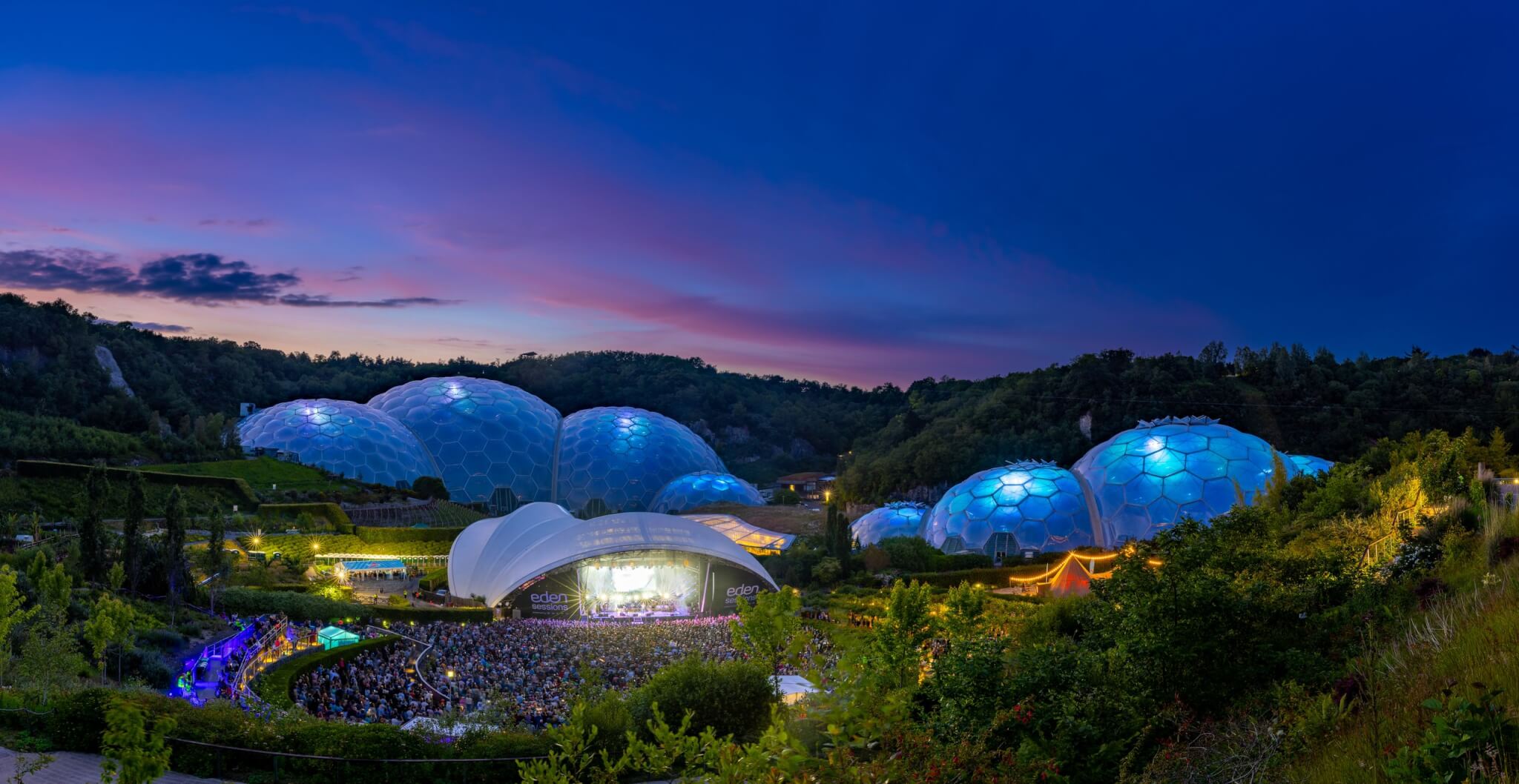 Eden Project Biomes lit up at dusk during an Eden Sessions gig