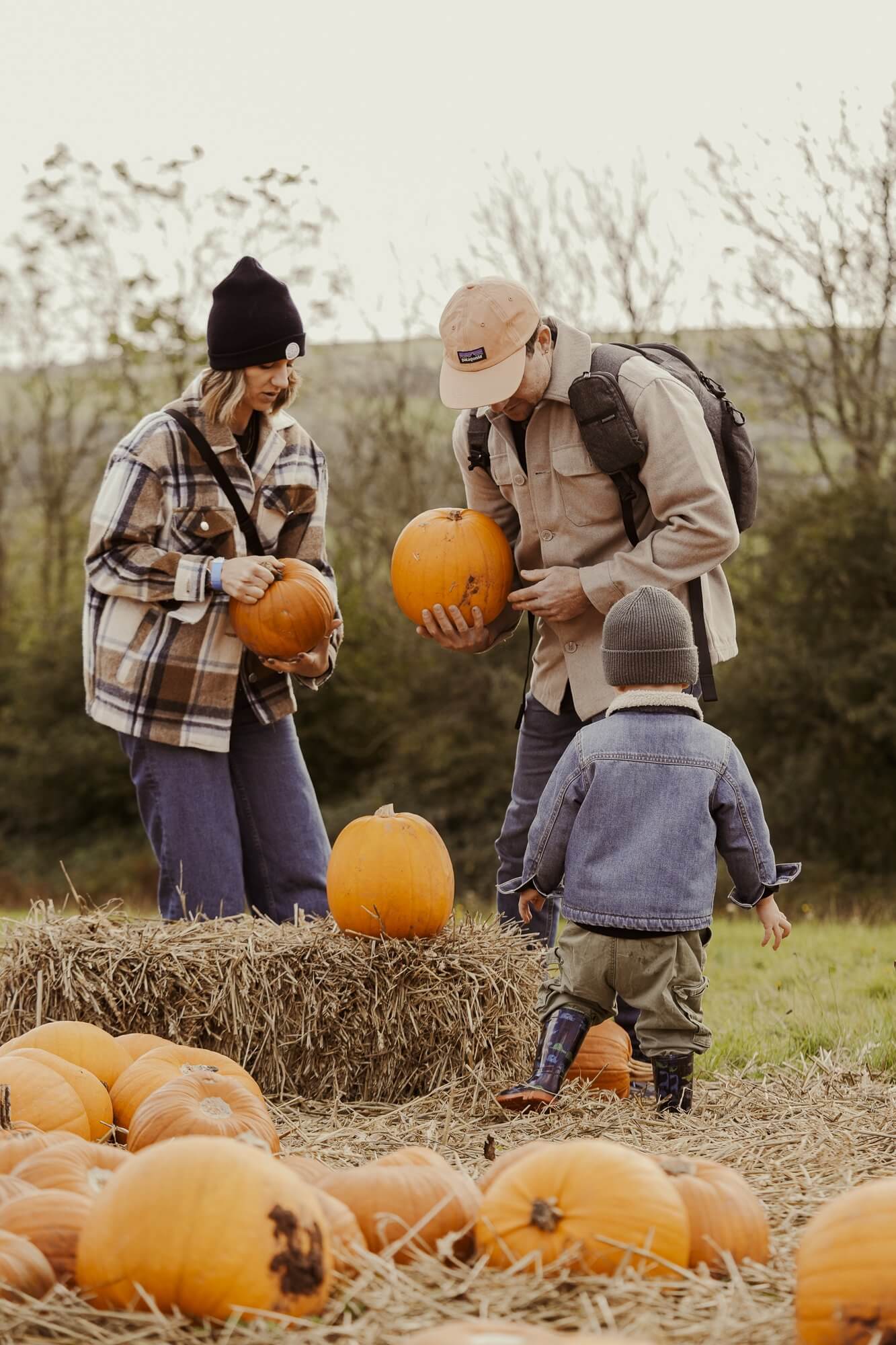 Family choosing pumpkins in the pumpkin patch