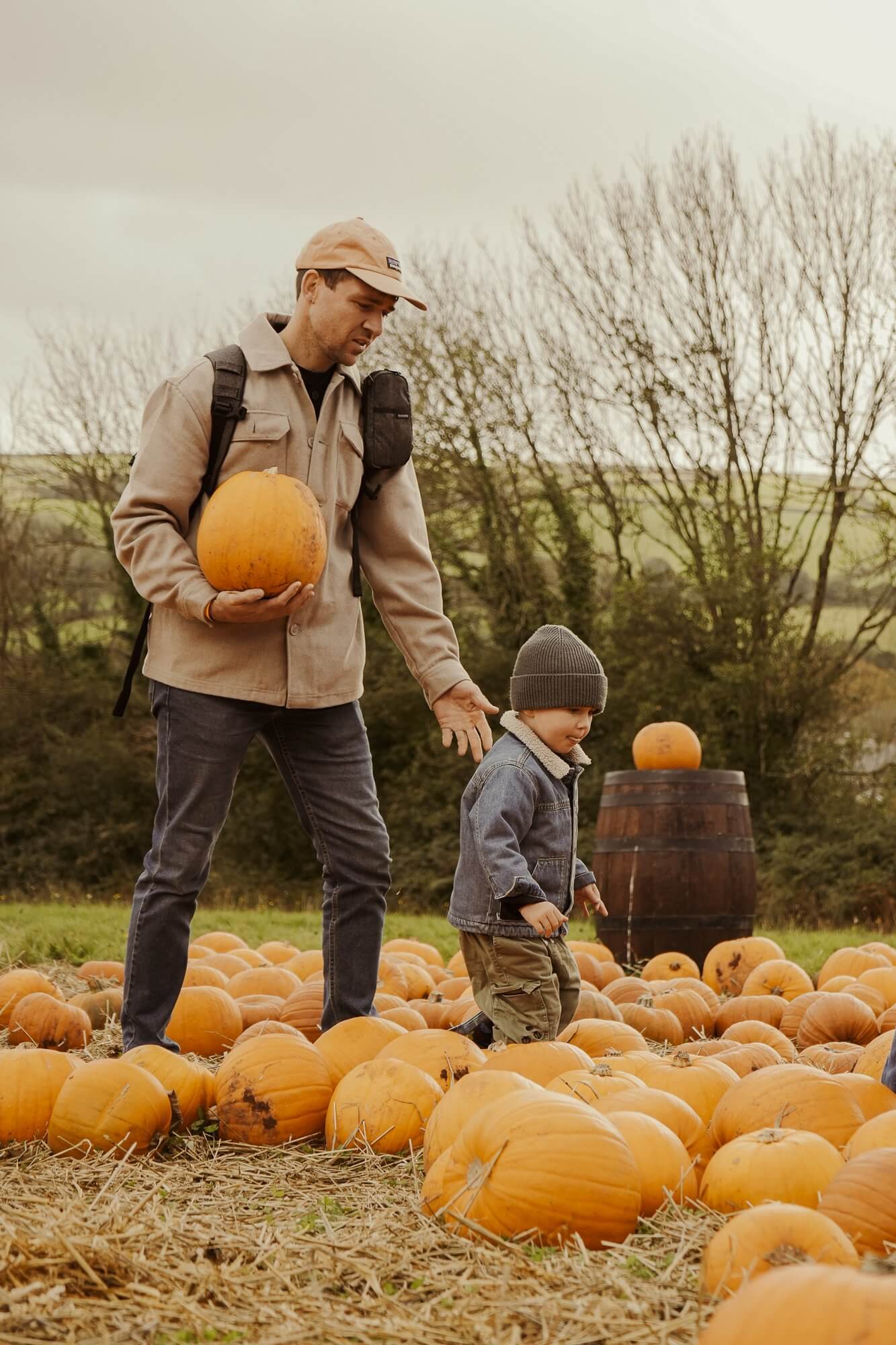 Father and young child in the pumpkin patch
