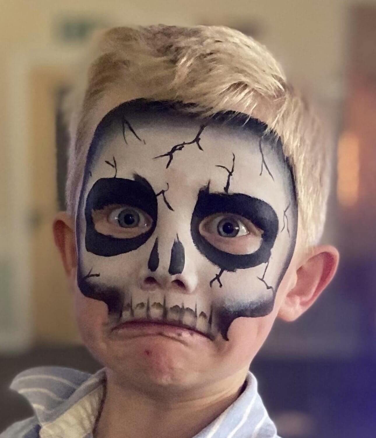 Child with Halloween skull facepaint