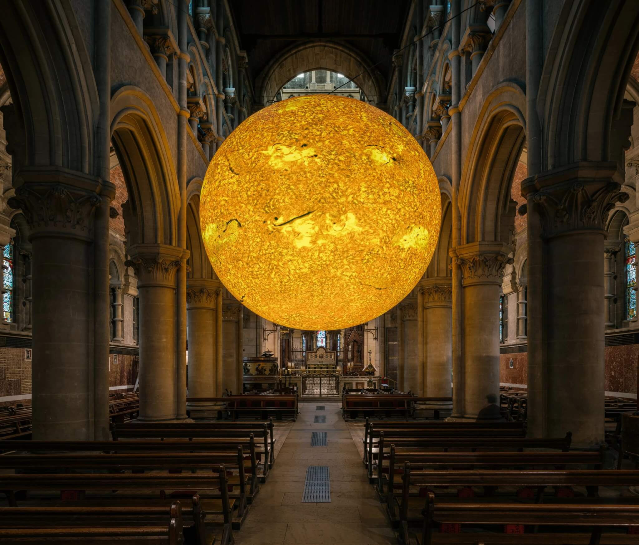 Helios Sun artwork hanging in a church nave in Cork