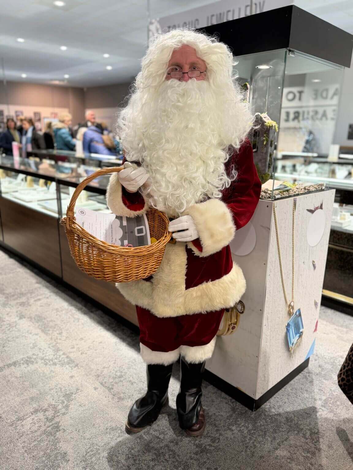 Santa holding a wicker basket at Cornwall Gold's Christmas Market
